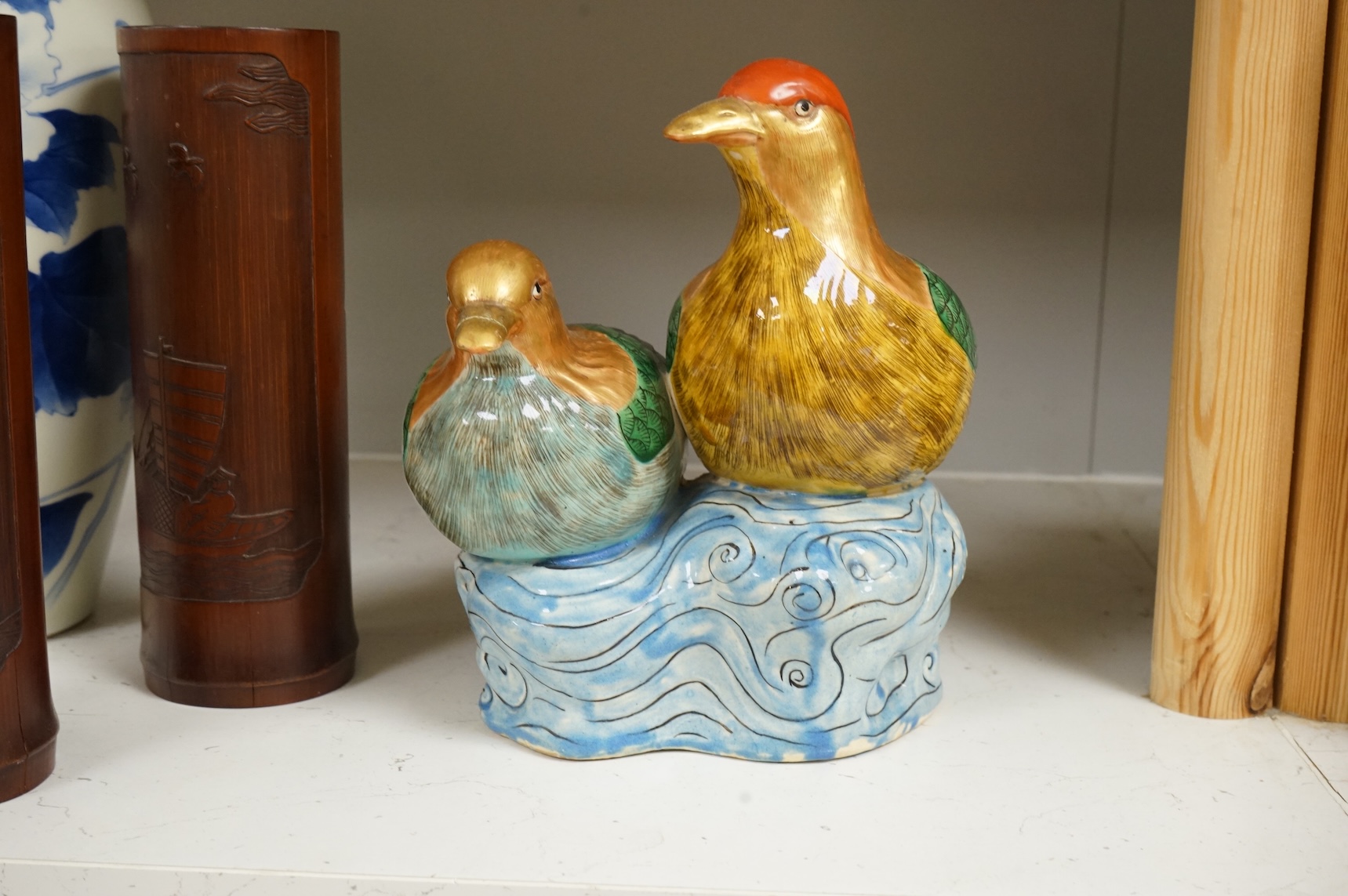 A Chinese Revolution Period porcelain bird group, 21.5cm, a pair of Chinese bamboo brushpots carved with figures and junks, each 22cm high, and a Japanese Seto blue and white vase, 29cm high